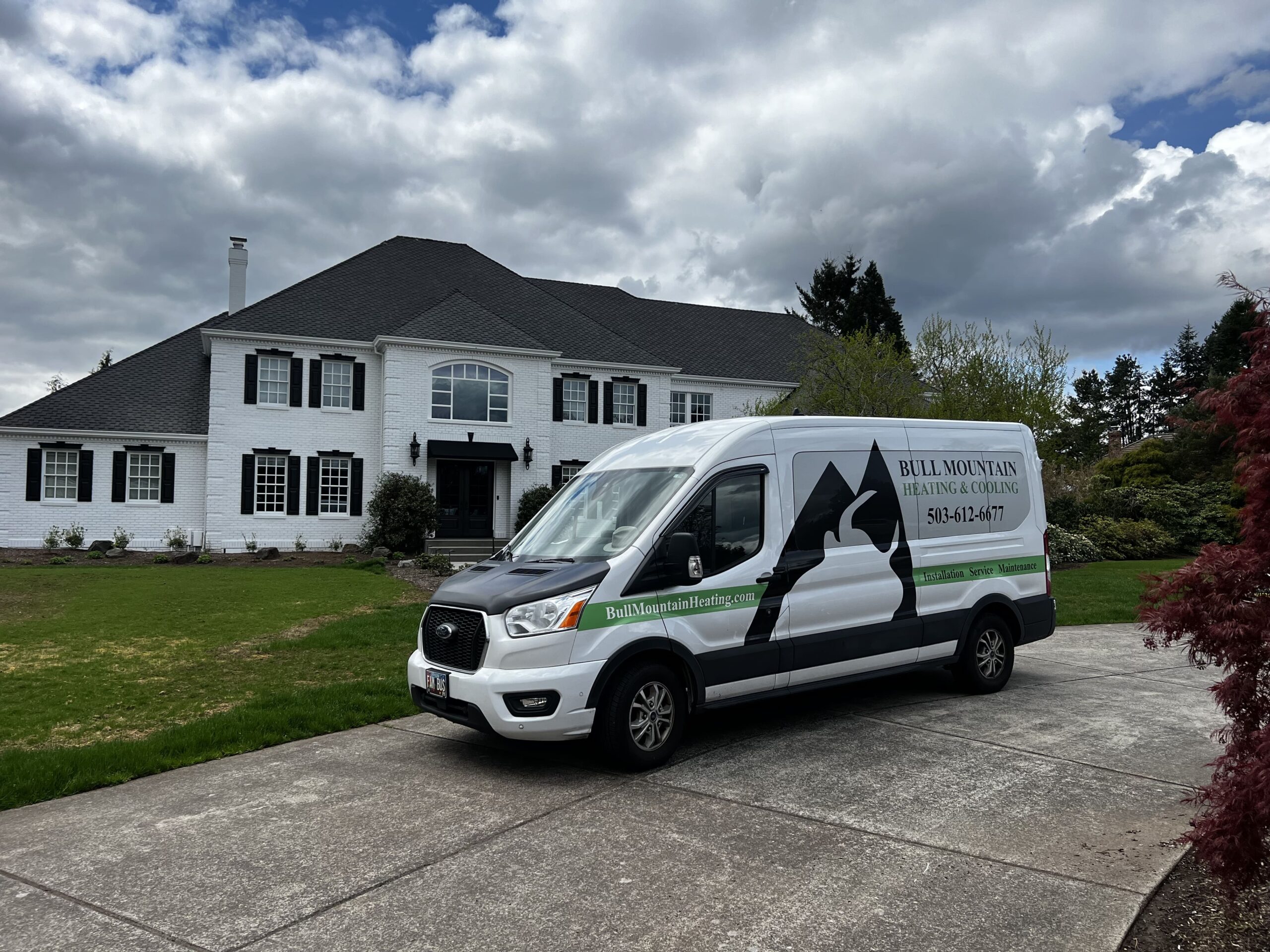 Bull Mountain Heating & Cooling service van parked in front of a residential home